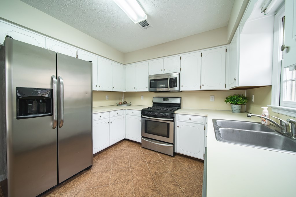 907 Eden Street Columbus, GA 31904 - Photo 15 of 26 a kitchen with a refrigerator stove and sink