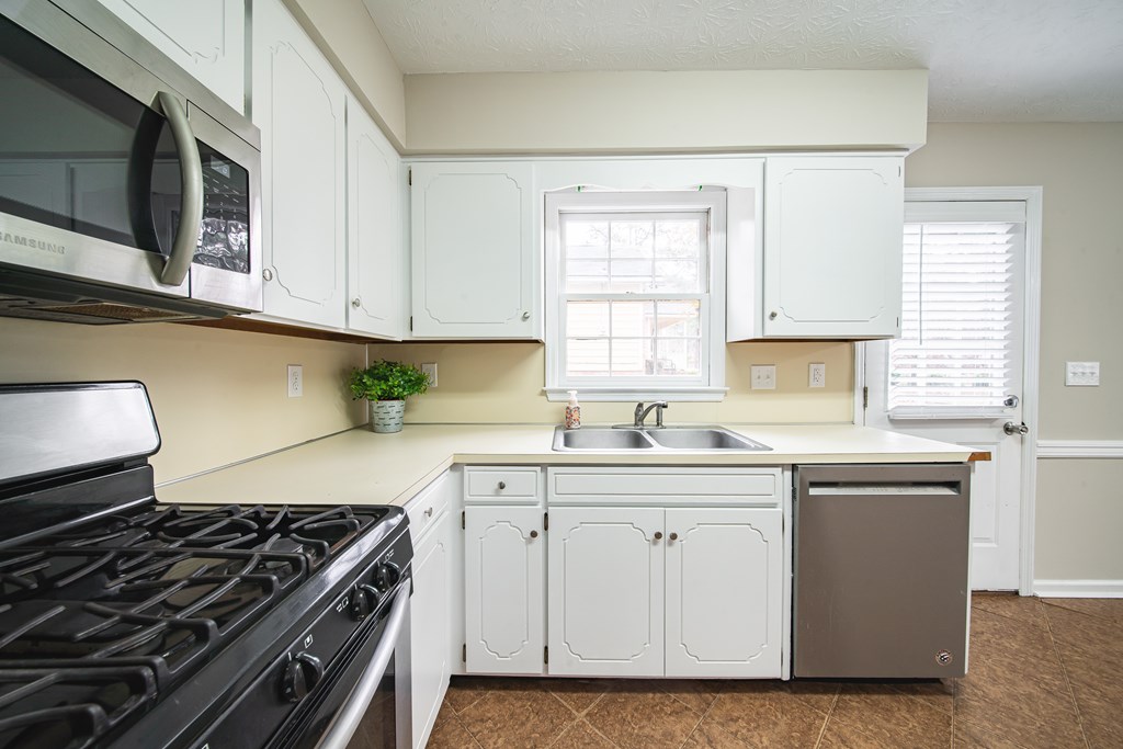 907 Eden Street Columbus, GA 31904 - Photo 17 of 26 a kitchen with stainless steel appliances granite countertop a sink stove and cabinets