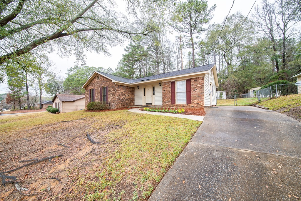 907 Eden Street Columbus, GA 31904 - Photo 2 of 26 a front view of a house with a yard and trees