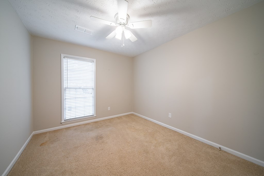 907 Eden Street Columbus, GA 31904 - Photo 26 of 26 an empty room with windows and ceiling fan
