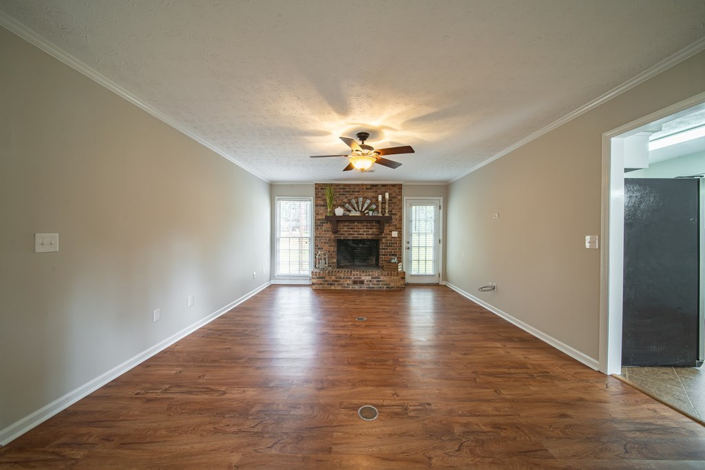 907 Eden Street Columbus, GA 31904 - Photo 10 of 26 a view of an empty room with a fireplace and a window