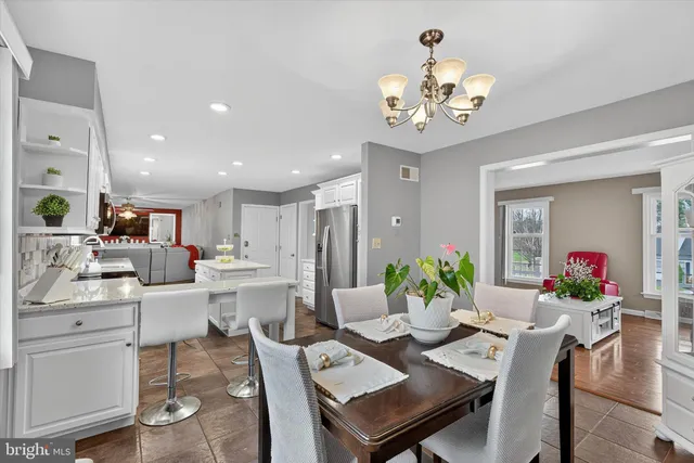 a kitchen with a sink a stove a refrigerator and white cabinets