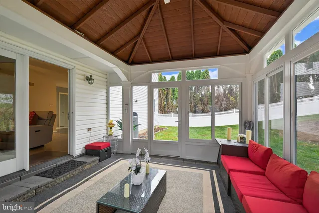 a living room with furniture a floor to ceiling window and a table