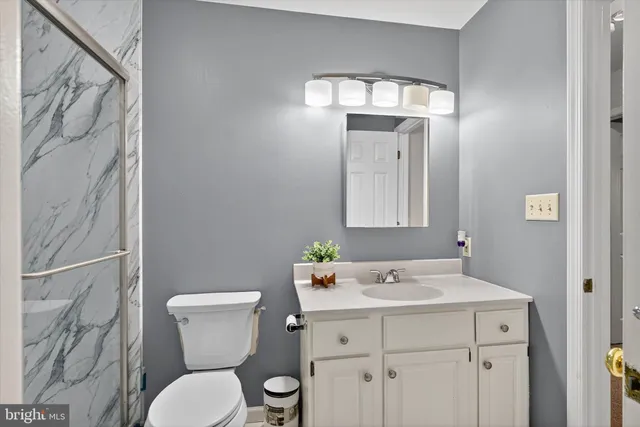 a bedroom with furniture and a lamp