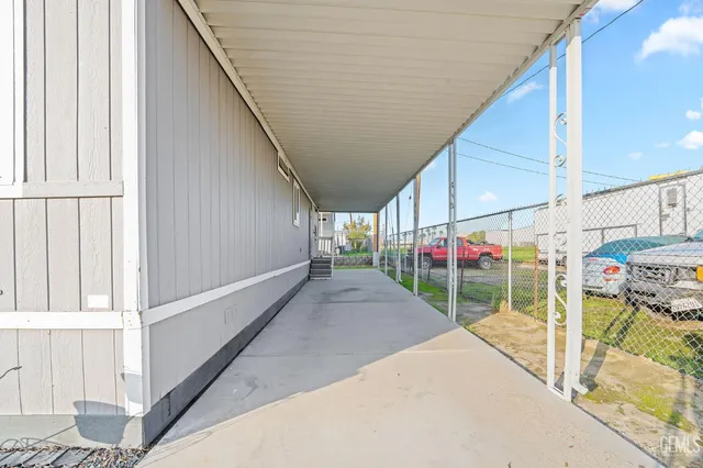 a view of a porch with wooden floor and fence