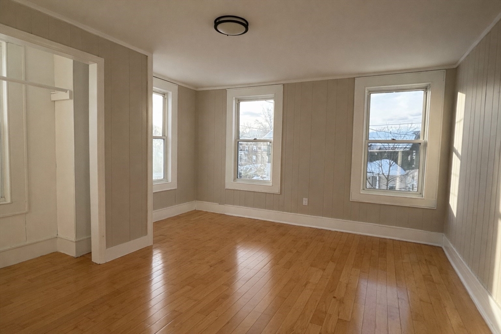 13 Hampden Street, Unit 2 Westfield, MA 01085 - Photo 2 of 7 a view of an empty room with wooden floor and a window