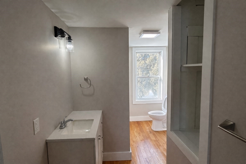 13 Hampden Street, Unit 2 Westfield, MA 01085 - Photo 5 of 7 a bathroom with a toilet sink and mirror