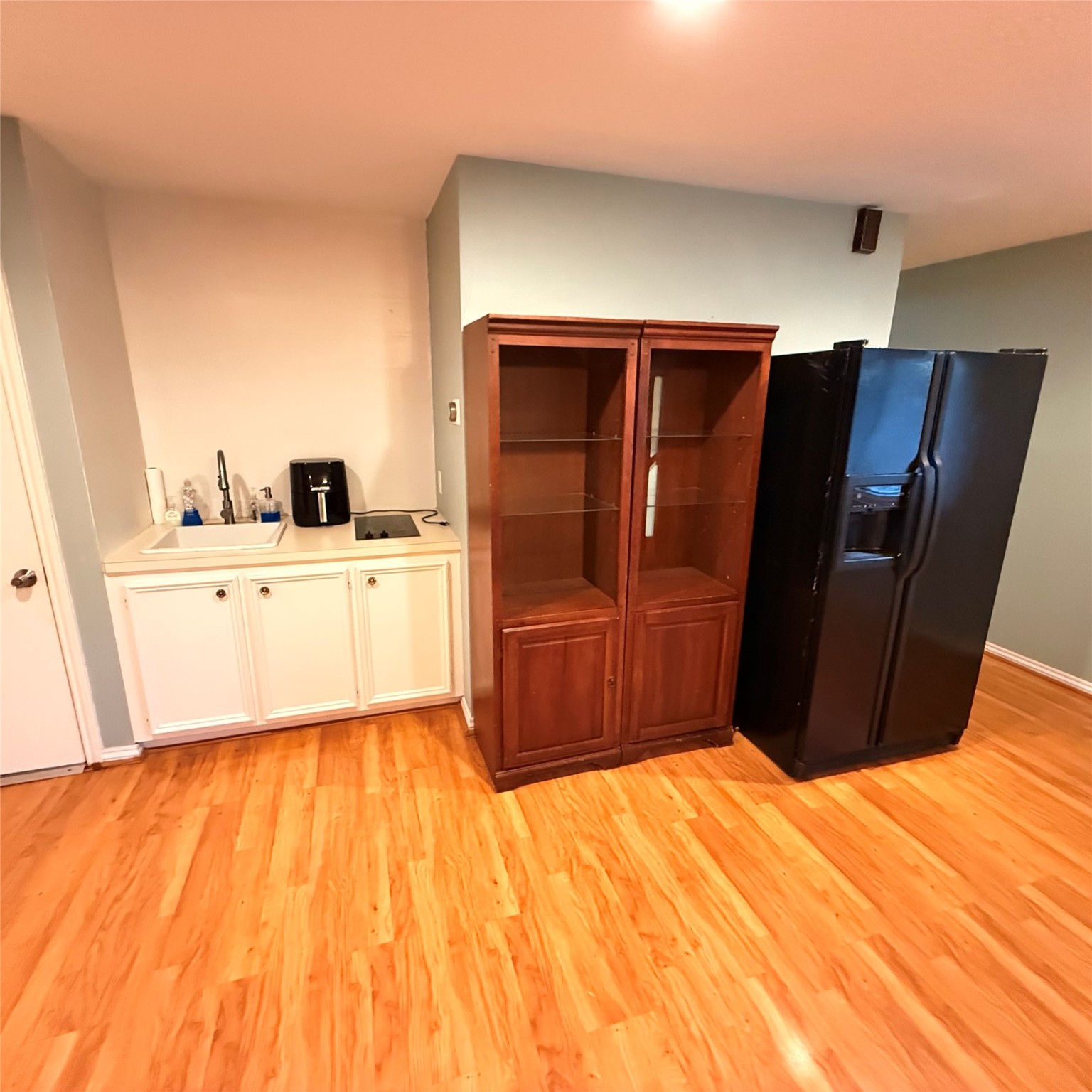 7338 Birchtree Forest Drive, Unit A Houston, TX 77088 - Photo 7 of 10 a kitchen with wooden cabinets and refrigerator