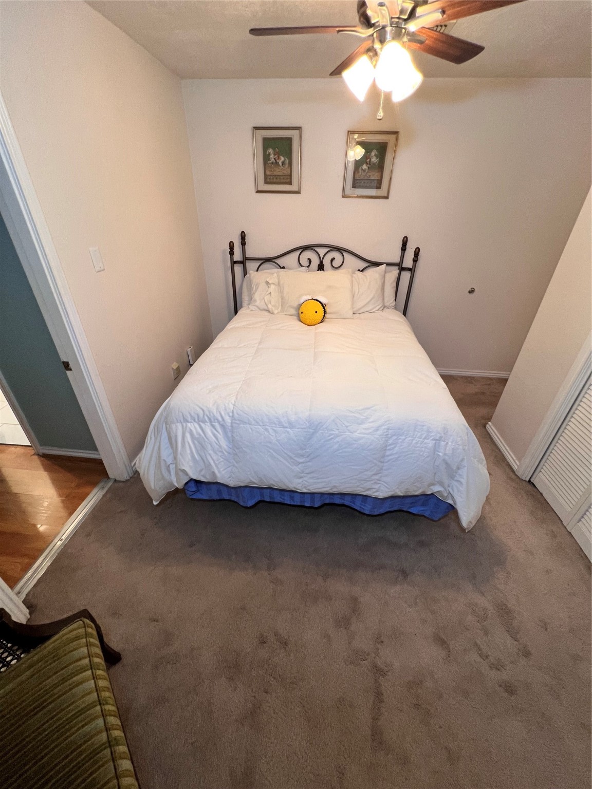 7338 Birchtree Forest Drive, Unit A Houston, TX 77088 - Photo 9 of 10 a bedroom with a bed and a chandelier