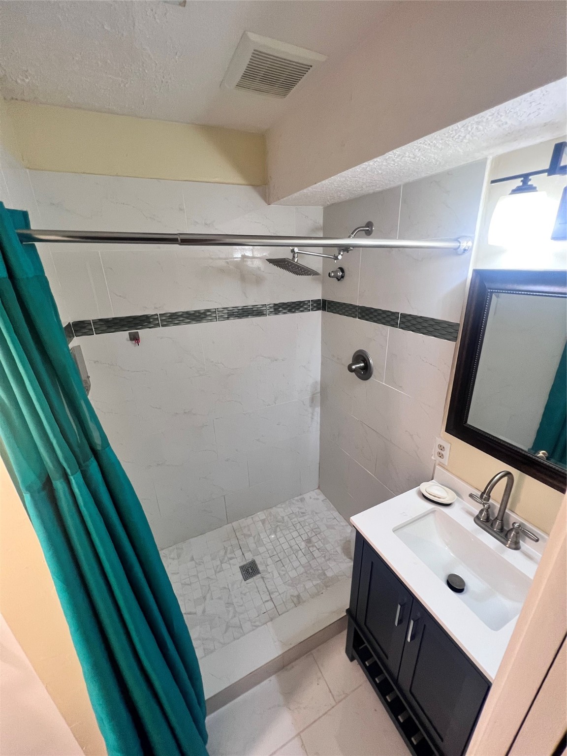 7338 Birchtree Forest Drive, Unit A Houston, TX 77088 - Photo 10 of 10 a bathroom with a sink a mirror and shower