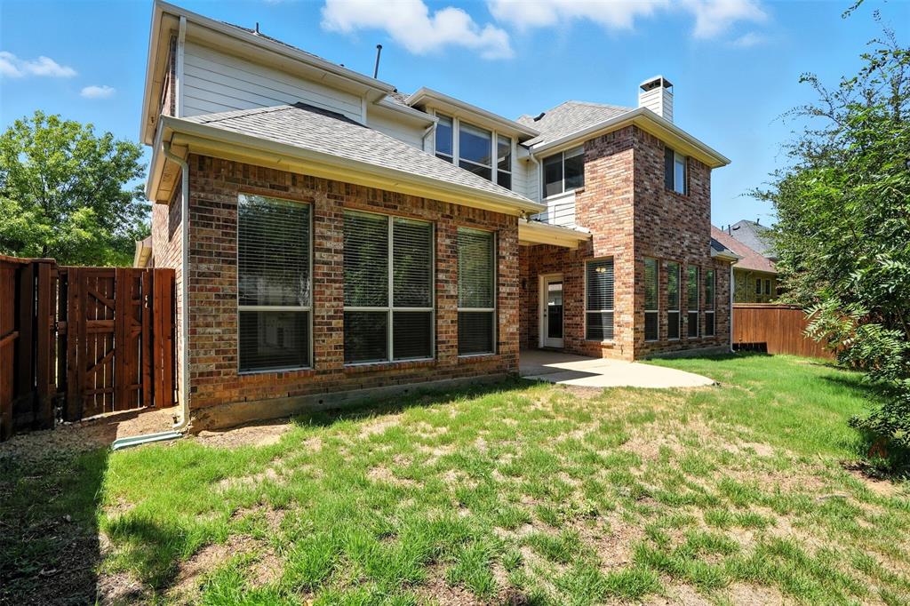 8220 Holliday Road Lantana, TX 76226 - Photo 38 of 40 Brick exterior with multiple windows and white siding accents