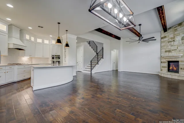 an empty room with wooden floor and fireplace