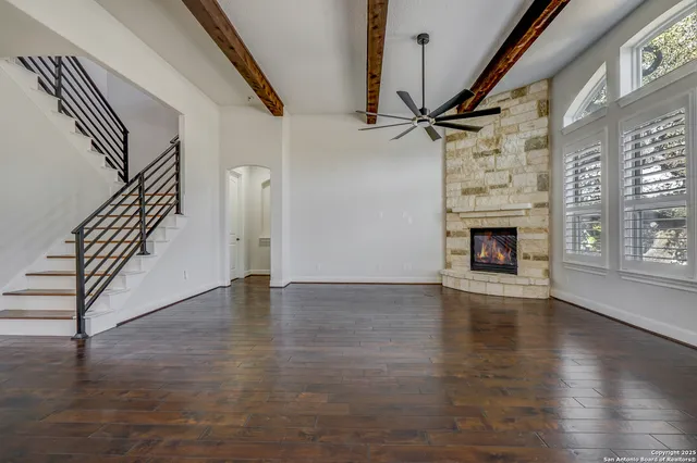 a view of a kitchen with refrigerator and wooden floor