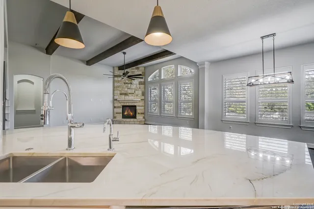 a view of a kitchen with refrigerator and wooden floor