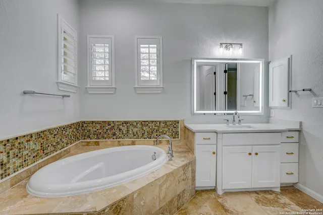 a bathroom with a shower sink and mirror