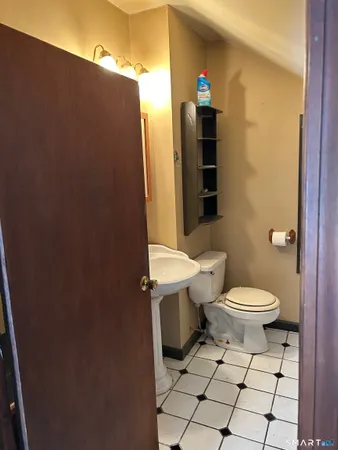 a bathroom with a toilet and a shower curtain