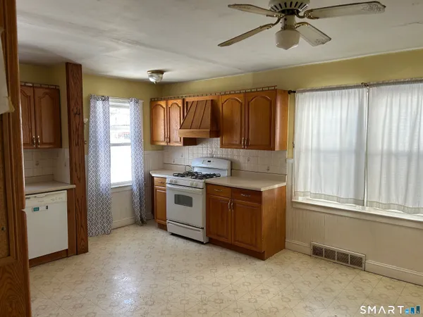 a kitchen with granite countertop a refrigerator and a sink