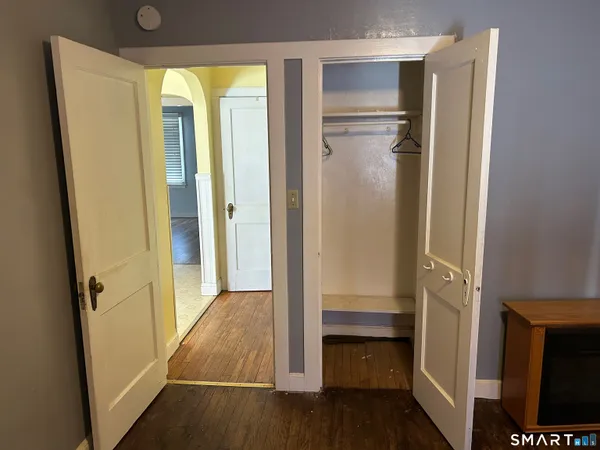 a view of walk in closet with empty room