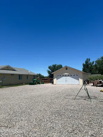 a view of a dry yard with a barn