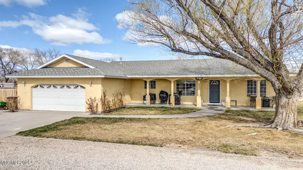 a view of a house with a patio and a yard