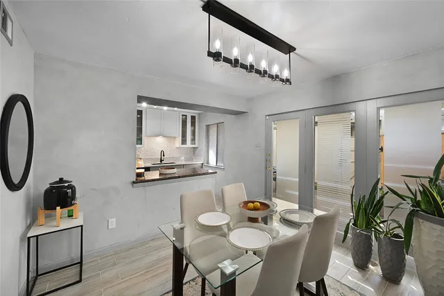 a view of a dining room with furniture and chandelier