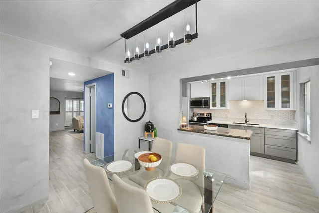 a large kitchen with a table and chairs