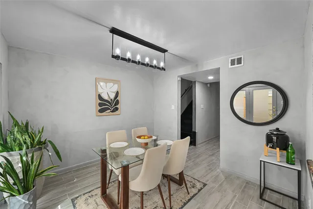a view of a dining room with furniture and a chandelier