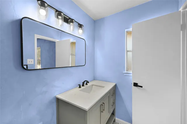 a bathroom with a sink and a mirror