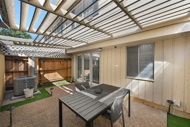 a backyard of a house with barbeque oven table and chairs