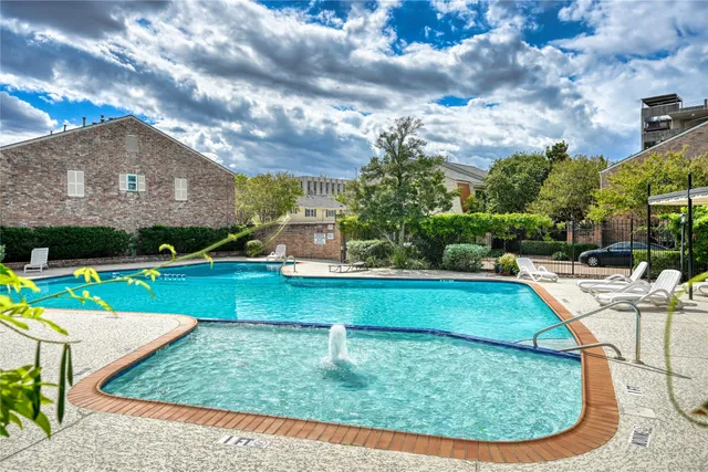 a view of a house with swimming pool and sitting area