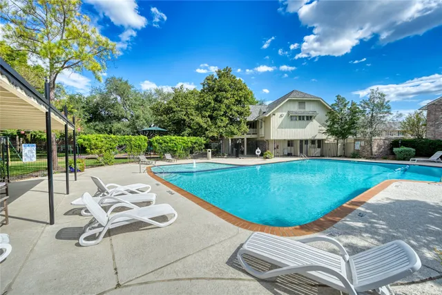 a view of a swimming pool with a patio
