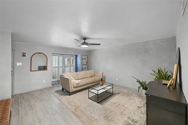 a living room with furniture and a potted plant