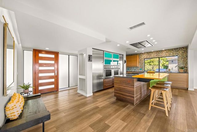 a dining room with furniture and a large window