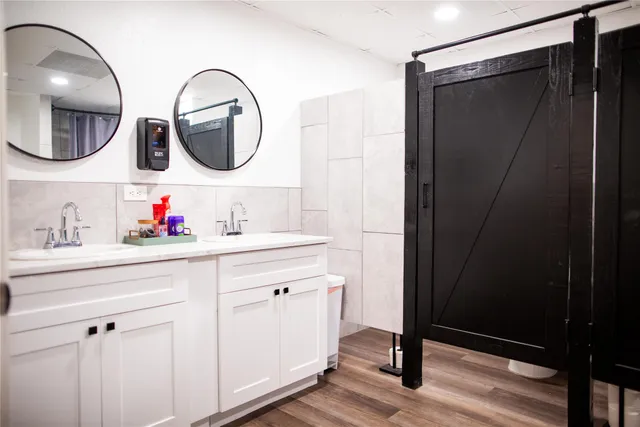 a bathroom with a double vanity sink and a mirror