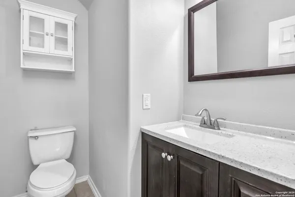 wooden floor in an empty room with a chandelier fan