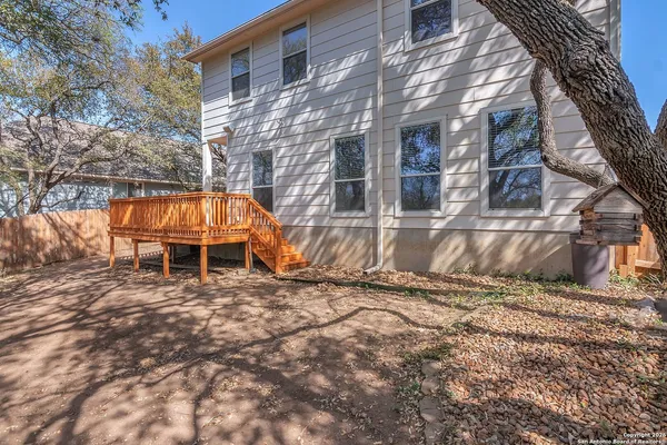 a backyard of a house with table and chairs