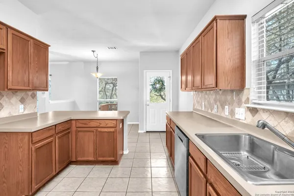 a kitchen with granite countertop a sink and cabinets