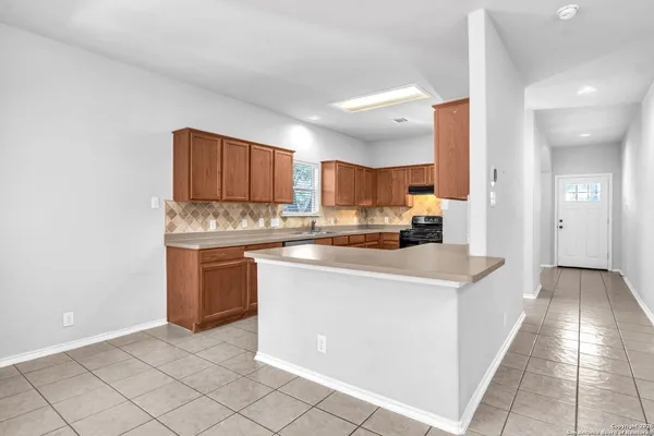 a kitchen with a sink stove and cabinets