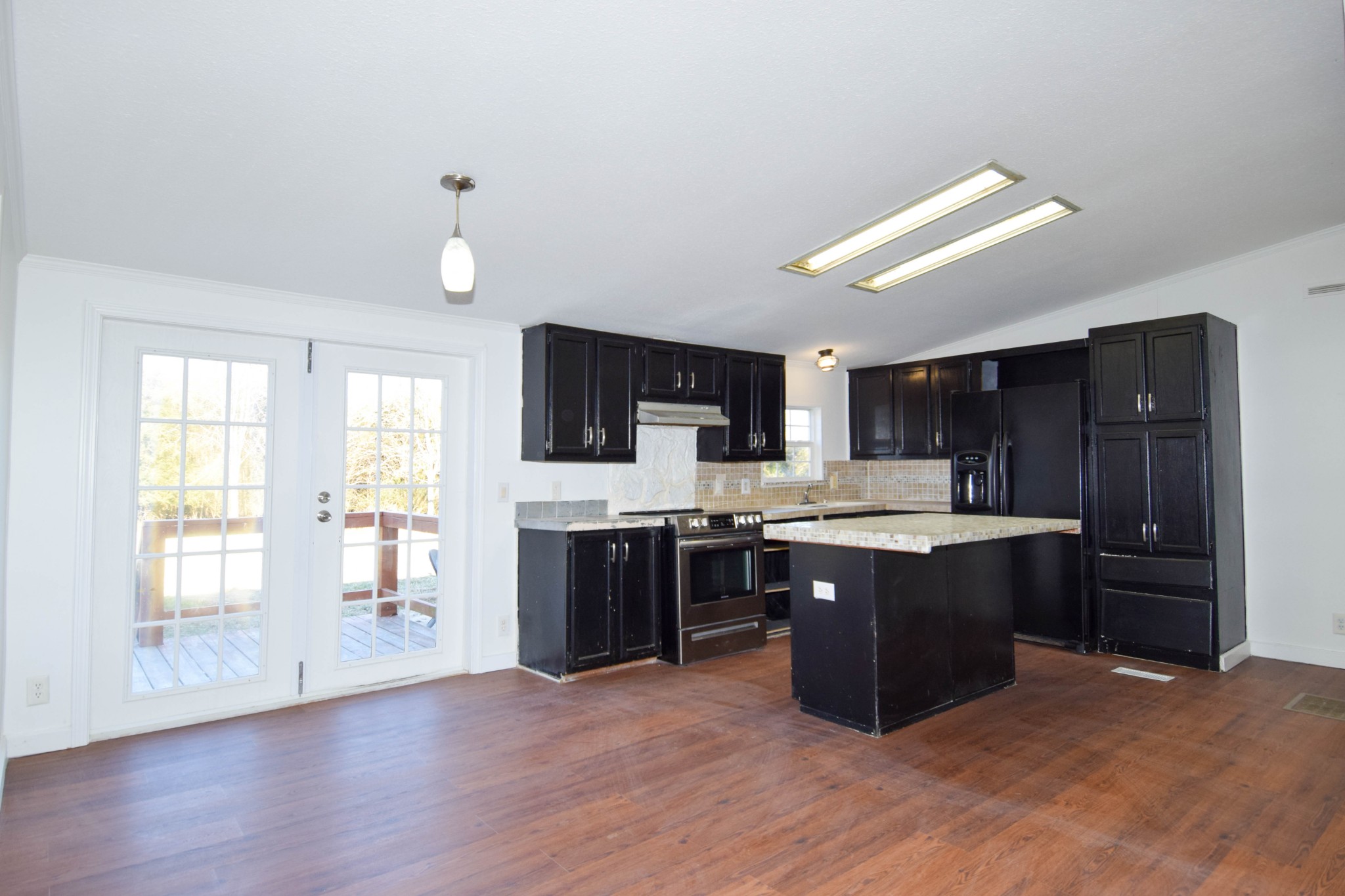 635 Celsor Road Hartsville, TN 37074 - Photo 13 of 44 a large kitchen with wooden floors and stainless steel appliances
