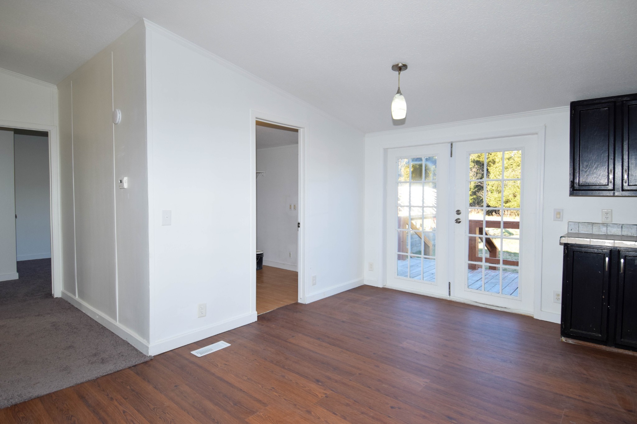 635 Celsor Road Hartsville, TN 37074 - Photo 20 of 44 a view of a kitchen and an empty room with wooden floor and a window
