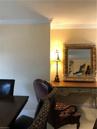 a living room with a couch and a potted plant
