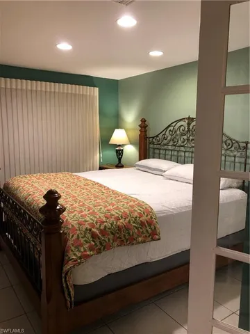 a bedroom with a bed and a lamp