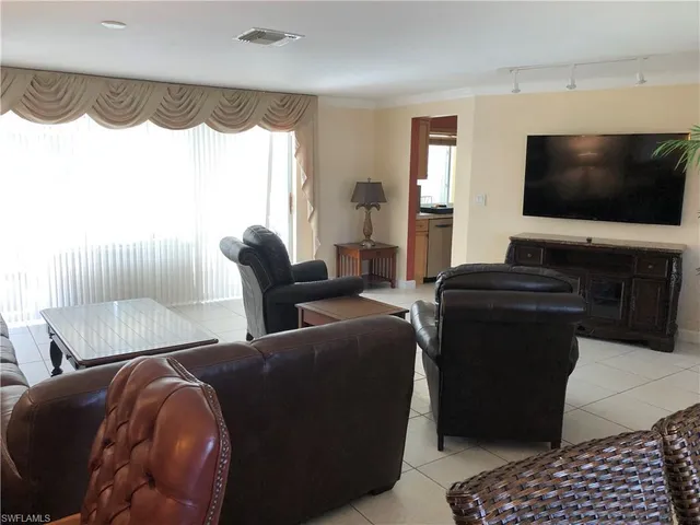 a view of a livingroom with furniture and a window