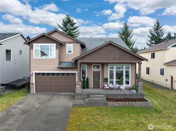 a front view of a house with a yard garage and outdoor seating