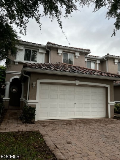 a front view of a house with garage