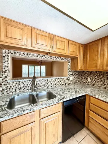 a kitchen with stainless steel appliances granite countertop a sink and cabinets