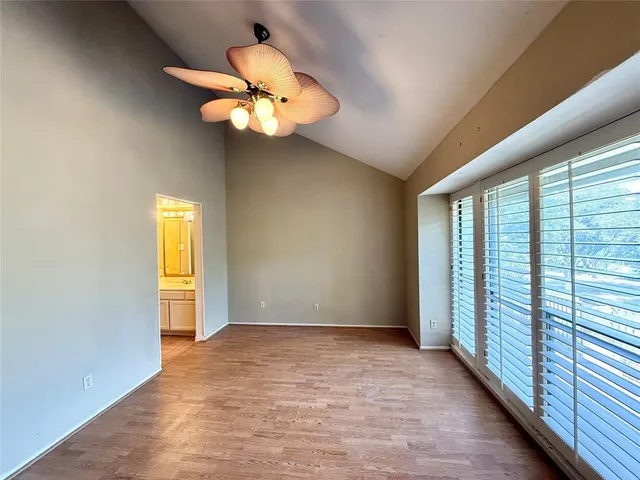 a view of a livingroom with a chandelier fan and a large window