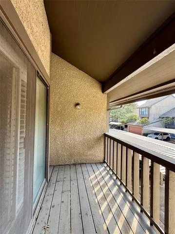a view of a balcony with wooden floor