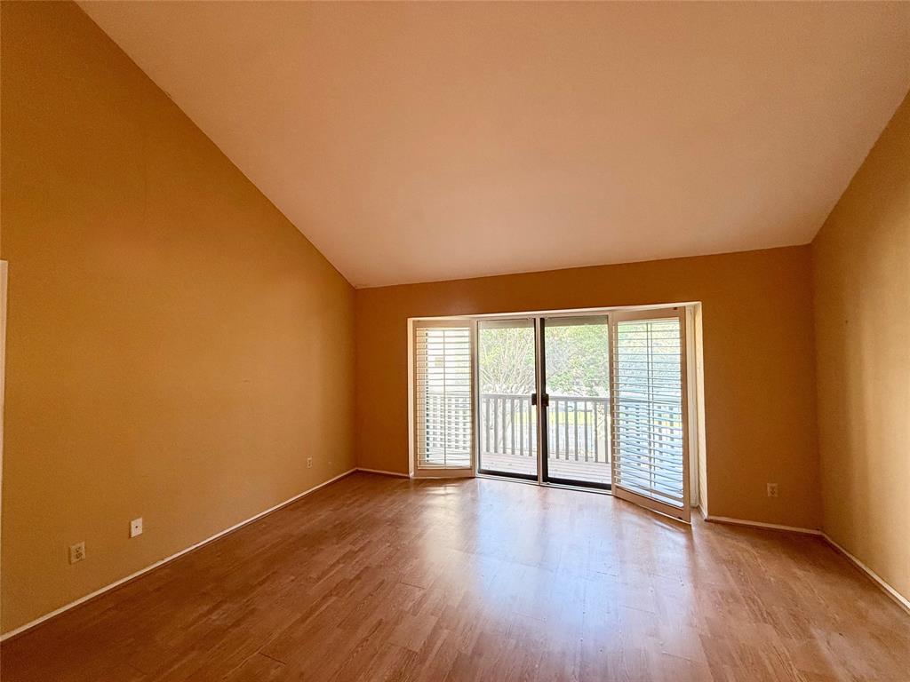 4513 North O'Connor Road, Unit 2133 Irving, TX 75062 - Photo 6 of 33 an empty room with wooden floor and windows