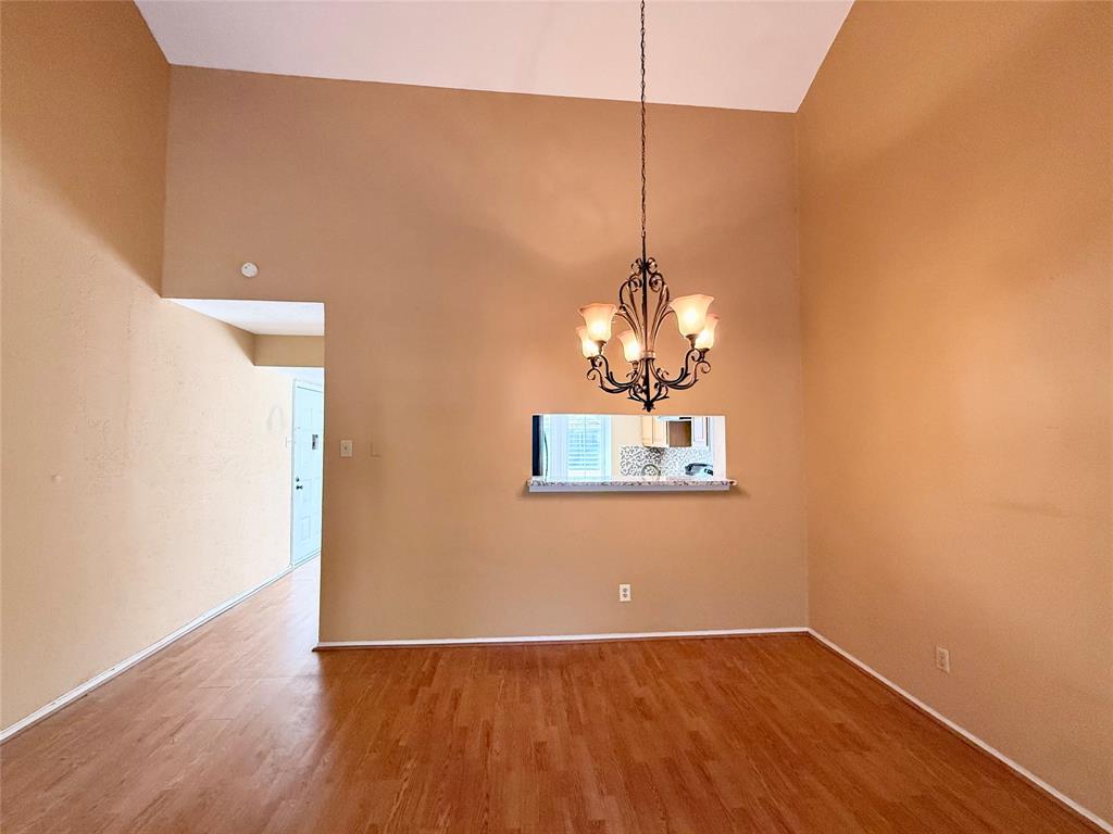 4513 North O'Connor Road, Unit 2133 Irving, TX 75062 - Photo 9 of 33 a view of a room with wooden floor and chandelier